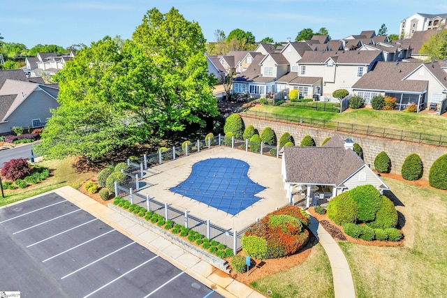 view of pool featuring fence and a residential view