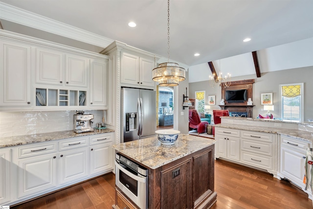 kitchen featuring white cabinets, stainless steel appliances, dark wood-type flooring, and a chandelier
