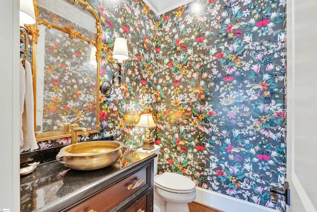 bathroom featuring wallpapered walls, vanity, and toilet
