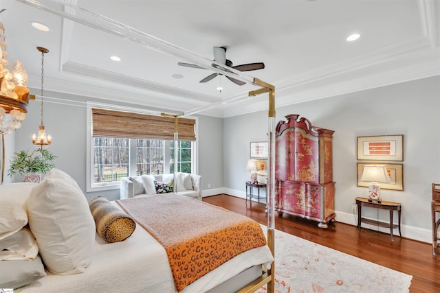 bedroom featuring a tray ceiling, baseboards, recessed lighting, crown molding, and dark wood-type flooring