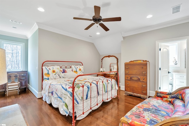 bedroom featuring baseboards, ornamental molding, wood finished floors, and visible vents