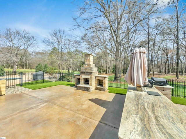 view of patio / terrace with fence, grilling area, and an outdoor stone fireplace
