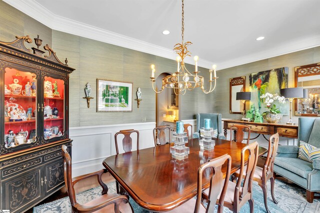 dining room featuring a notable chandelier, crown molding, wainscoting, and recessed lighting