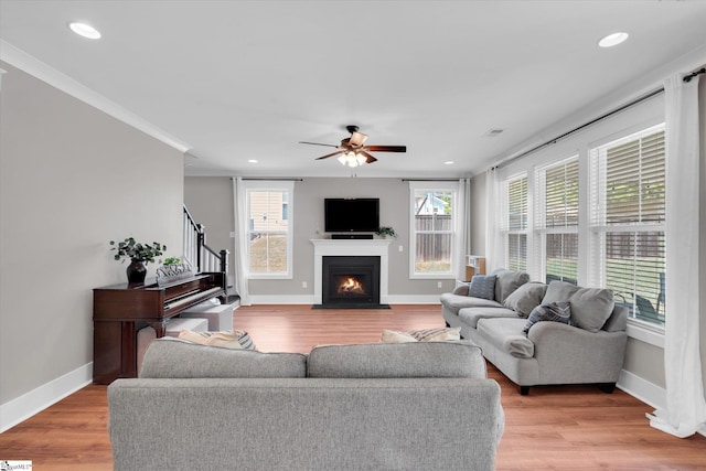 200 Noble St, Greer, SC 29651 - living room featuring a fireplace with flush hearth, a ceiling fan, baseboards, and light wood-style floors