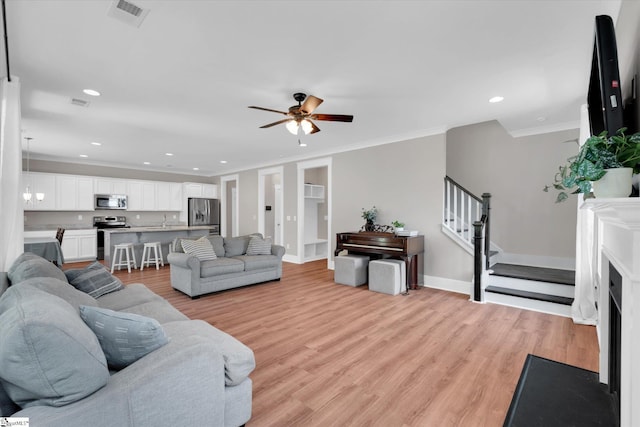 200 Noble St, Greer, SC 29651 - living area with light wood-style flooring, visible vents, recessed lighting, ceiling fan, and ornamental molding