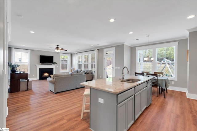 200 Noble St, Greer, SC 29651 - kitchen with stainless steel dishwasher, a sink, ceiling fan with notable chandelier, baseboards, and gray cabinetry