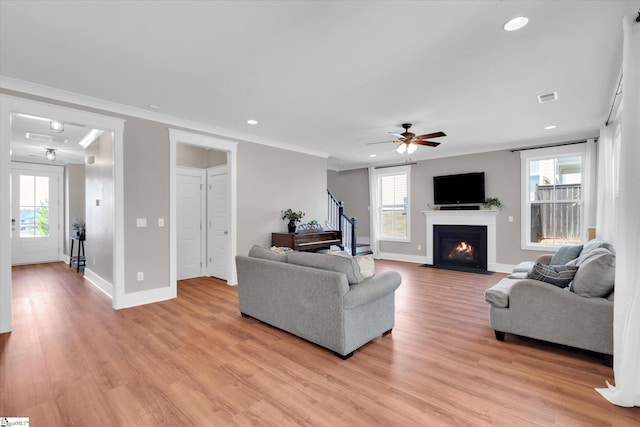 200 Noble St, Greer, SC 29651 - living room featuring light wood finished floors, visible vents, a wealth of natural light, and stairs