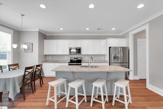200 Noble St, Greer, SC 29651 - kitchen with a kitchen island with sink, a sink, a kitchen bar, crown molding, and appliances with stainless steel finishes