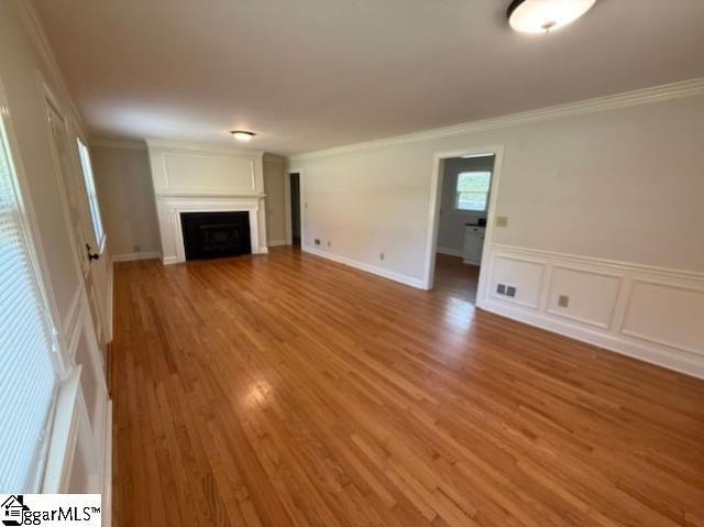 28 Alpine Way, Greenville, SC 29609 - unfurnished living room featuring a fireplace, light wood finished floors, and ornamental molding