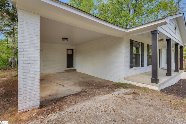 181 Skyland Dr, Clinton, SC 29325 - doorway to property with brick siding and an attached carport
