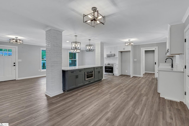 181 Skyland Dr, Clinton, SC 29325 - kitchen featuring a chandelier, appliances with stainless steel finishes, gray cabinetry, and decorative columns