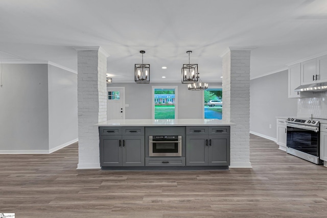 181 Skyland Dr, Clinton, SC 29325 - kitchen with gray cabinets, baseboards, appliances with stainless steel finishes, and ornate columns