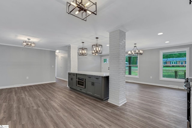 181 Skyland Dr, Clinton, SC 29325 - bar featuring dark wood-type flooring, decorative columns, baseboards, and an inviting chandelier