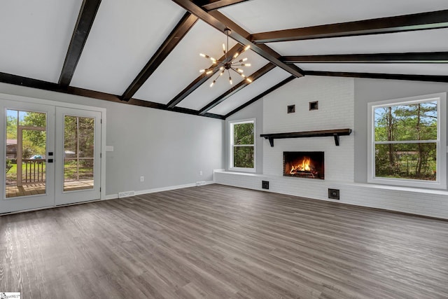 181 Skyland Dr, Clinton, SC 29325 - unfurnished living room featuring vaulted ceiling with beams, visible vents, a notable chandelier, wood finished floors, and a brick fireplace