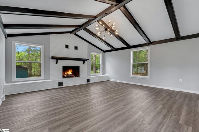 181 Skyland Dr, Clinton, SC 29325 - unfurnished living room with beamed ceiling, wood finished floors, baseboards, and an inviting chandelier
