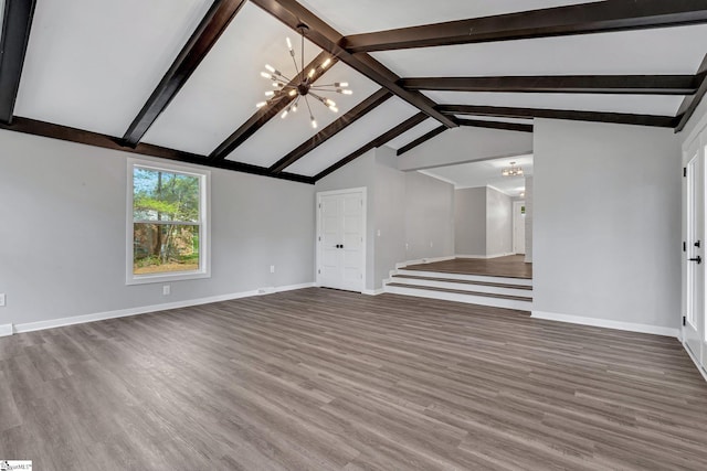 181 Skyland Dr, Clinton, SC 29325 - unfurnished living room with lofted ceiling with beams, baseboards, wood finished floors, and a chandelier