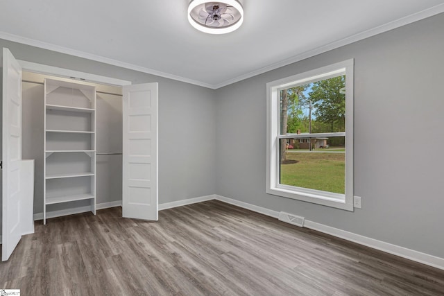 181 Skyland Dr, Clinton, SC 29325 - unfurnished bedroom featuring baseboards, crown molding, and wood finished floors