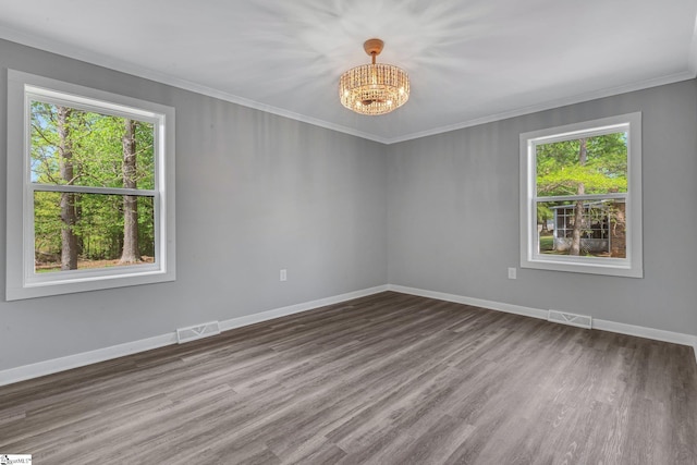 181 Skyland Dr, Clinton, SC 29325 - unfurnished room with baseboards, a wealth of natural light, wood finished floors, and an inviting chandelier