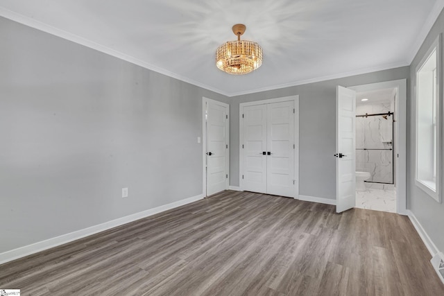 181 Skyland Dr, Clinton, SC 29325 - unfurnished bedroom with an inviting chandelier, wood finished floors, ornamental molding, baseboards, and ensuite bathroom