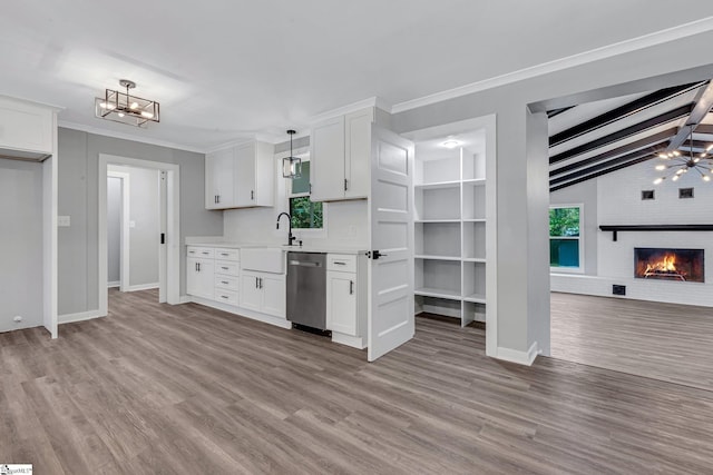 181 Skyland Dr, Clinton, SC 29325 - kitchen featuring a sink, dishwasher, light wood finished floors, light countertops, and a notable chandelier