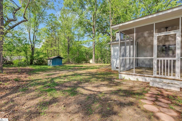 181 Skyland Dr, Clinton, SC 29325 - view of yard with an outdoor structure, a storage unit, and a sunroom