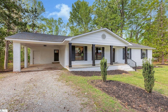181 Skyland Dr, Clinton, SC 29325 - ranch-style house featuring a carport, covered porch, driveway, and brick siding