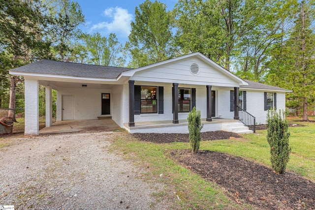 181 Skyland Dr, Clinton, SC 29325 - ranch-style house with a front lawn, an attached carport, driveway, a porch, and brick siding