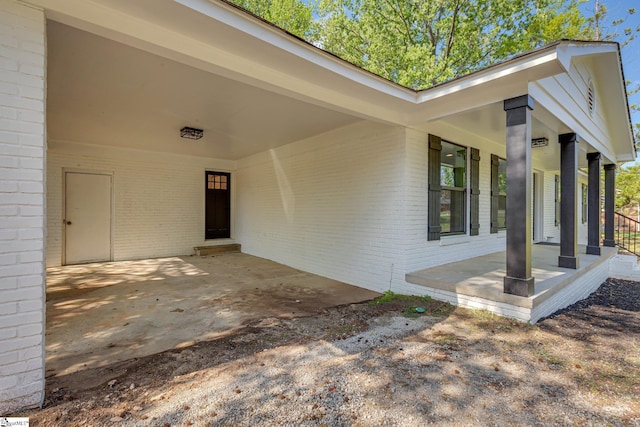 181 Skyland Dr, Clinton, SC 29325 - entrance to property featuring brick siding, a carport, and a porch