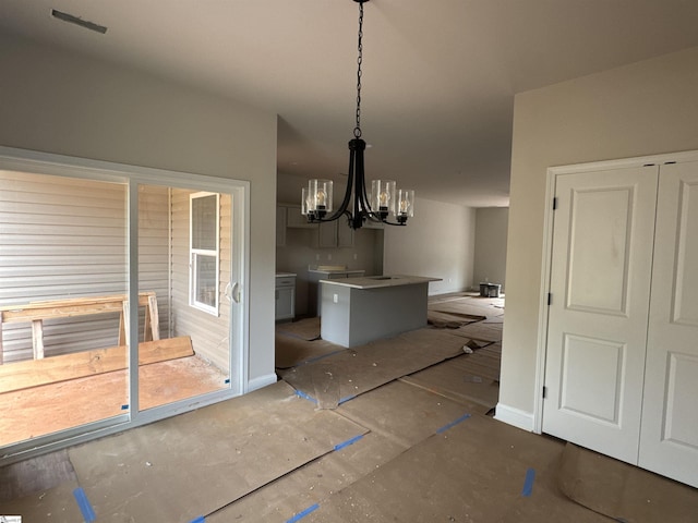 dining space with visible vents and a notable chandelier