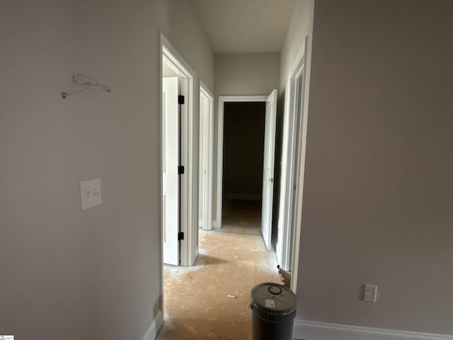 corridor featuring baseboards