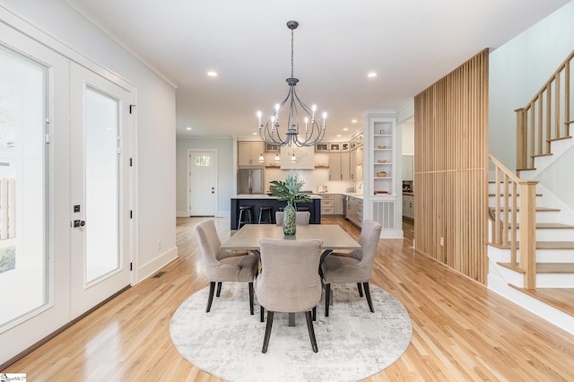 827 S Academy St, Greenville, SC 29601 - dining room featuring a notable chandelier, light wood-style floors, stairs, and ornamental molding