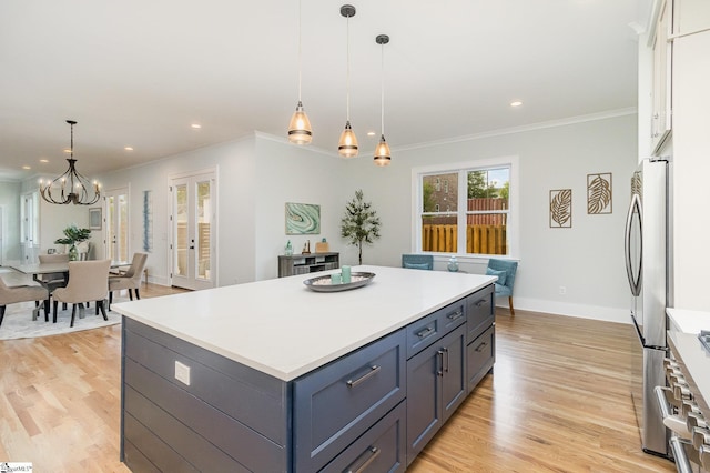 827 S Academy St, Greenville, SC 29601 - kitchen with stainless steel appliances, light wood-style flooring, ornamental molding, and an inviting chandelier