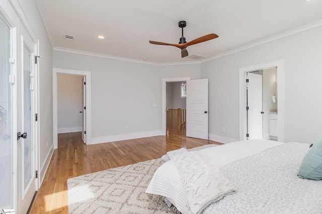 827 S Academy St, Greenville, SC 29601 - bedroom with visible vents, baseboards, wood finished floors, ornamental molding, and a walk in closet