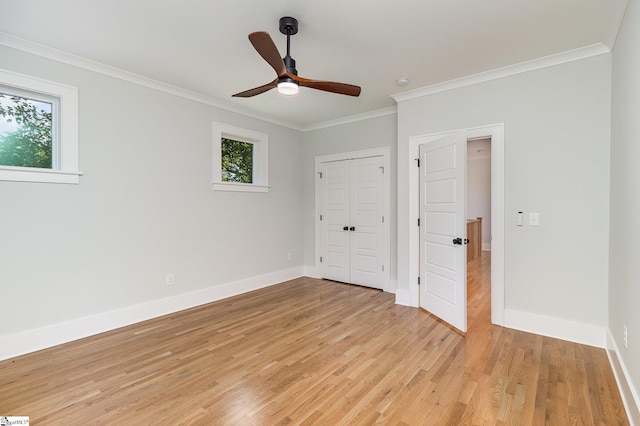827 S Academy St, Greenville, SC 29601 - unfurnished bedroom with multiple windows, light wood-style flooring, baseboards, and crown molding