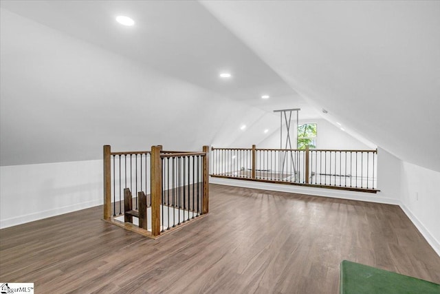 additional living space with recessed lighting, vaulted ceiling, wood finished floors, and baseboards
