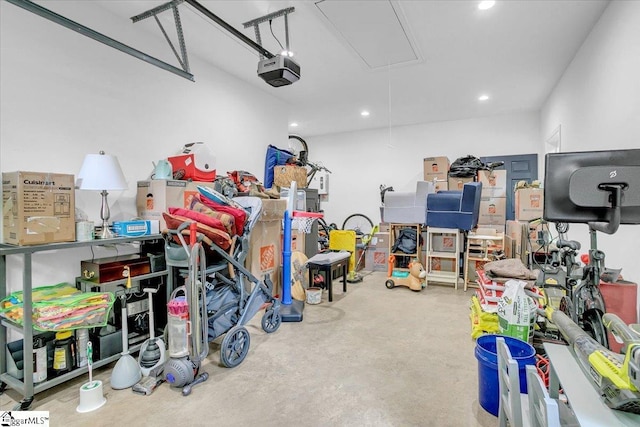 garage with recessed lighting and a garage door opener