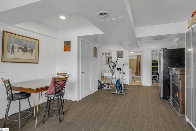 108A Holt Dr, Iva, SC 29655 - exercise room with a glass covered fireplace, dark colored carpet, and visible vents