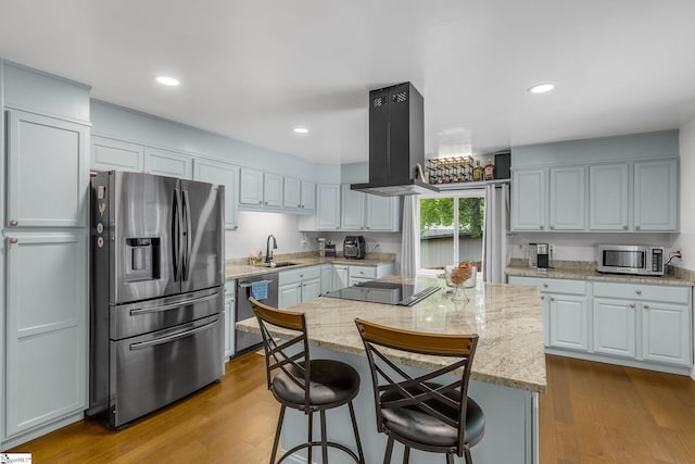 108A Holt Dr, Iva, SC 29655 - kitchen featuring light stone counters, a center island, a sink, island range hood, and appliances with stainless steel finishes