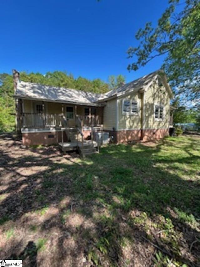 rear view of house with a yard