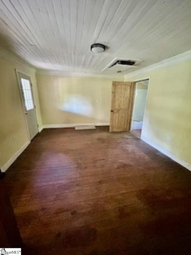 empty room with wooden ceiling, baseboards, crown molding, and wood finished floors