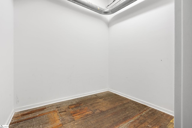 walk in closet featuring dark wood-type flooring