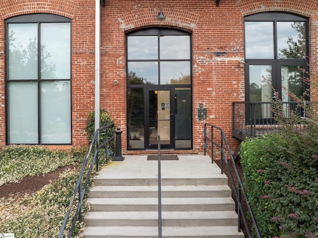 entrance to property with brick siding and french doors