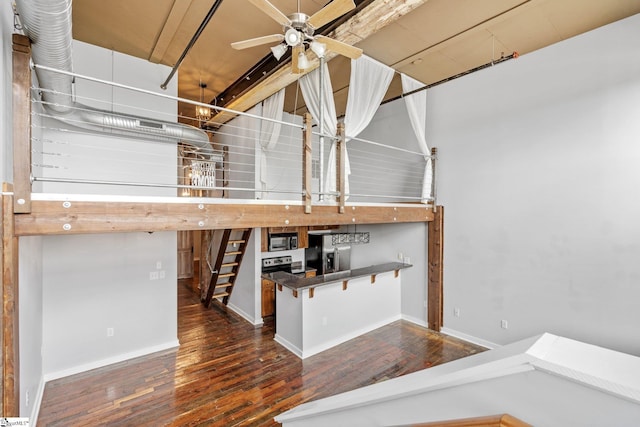 basement with stainless steel fridge, wood finished floors, a ceiling fan, and baseboards