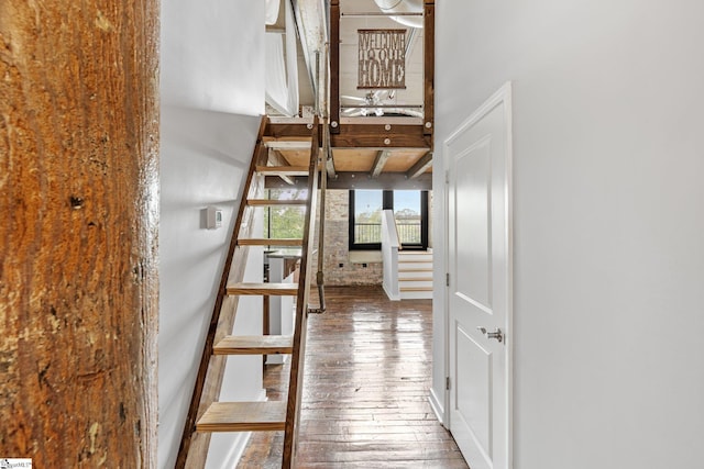 hallway featuring beam ceiling and wood-type flooring