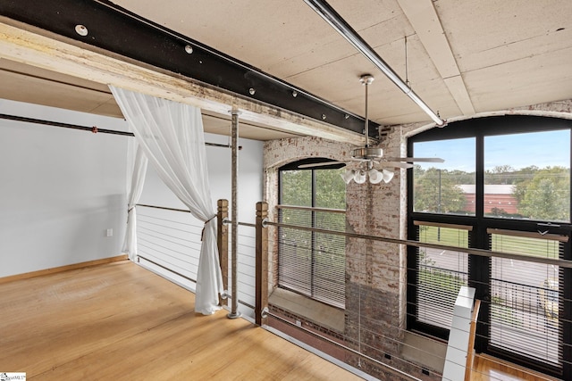 interior space with ceiling fan, baseboards, and wood finished floors