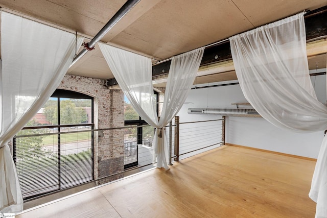 additional living space featuring wood finished floors and baseboards