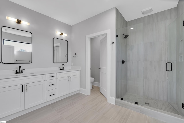 512 Anderson St Unit 1, Greenville, SC 29601 - full bathroom with double vanity, a shower stall, toilet, and a sink