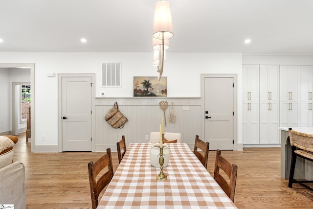 dining room with a wainscoted wall, light wood-style floors, visible vents, and recessed lighting