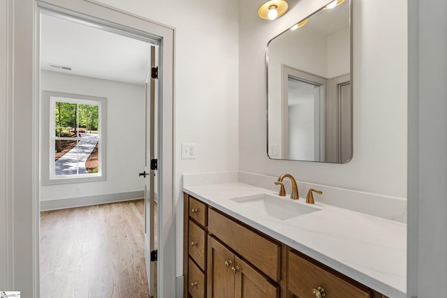 bathroom featuring wood finished floors, visible vents, and vanity