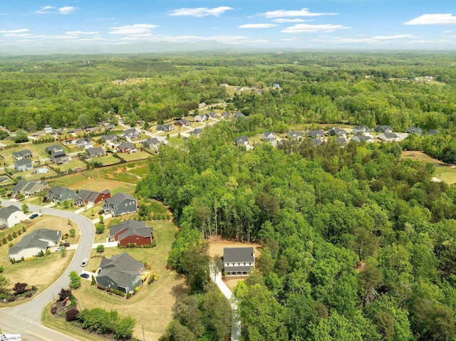 drone / aerial view with a view of trees and a residential view